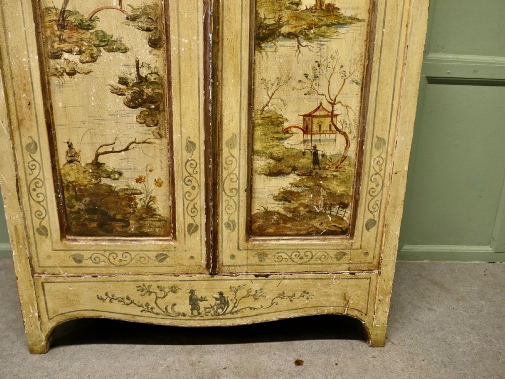 A tall, cream-painted antique cupboard featuring hand-painted Chinoiserie landscape scenes across two full-length doors and an arched pediment. View VI
