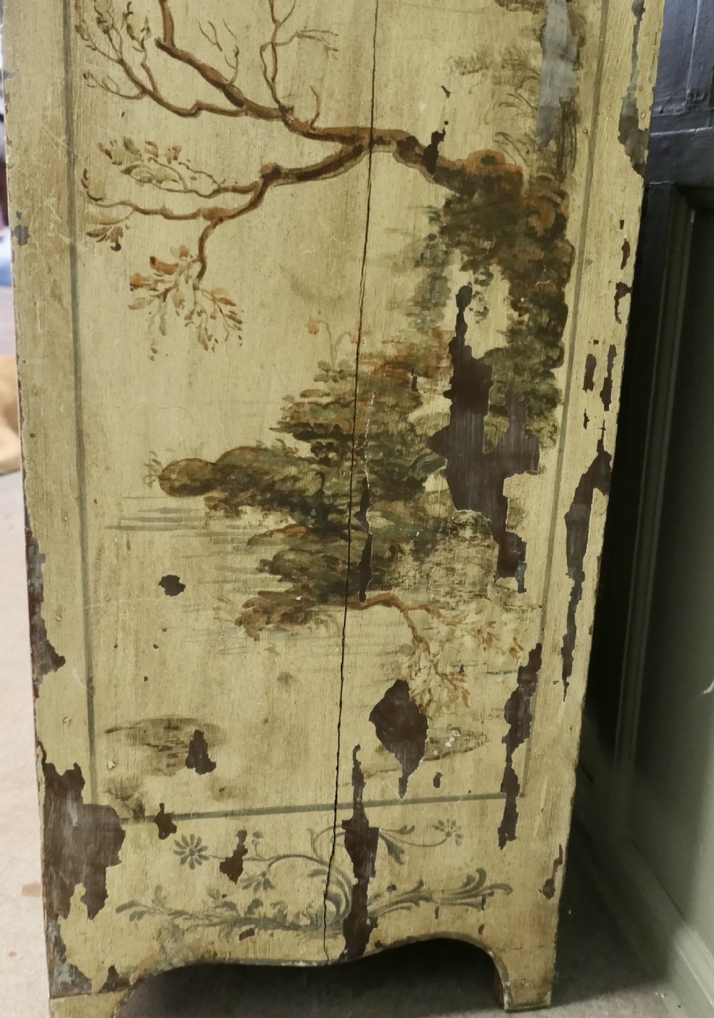 A tall, cream-painted antique cupboard featuring hand-painted Chinoiserie landscape scenes across two full-length doors and an arched pediment. View VII