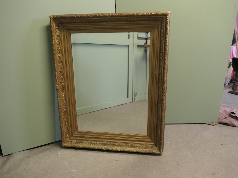 A large nineteenth-century rectangular wall mirror featuring a heavily moulded giltwood frame with classic border detailing. View II