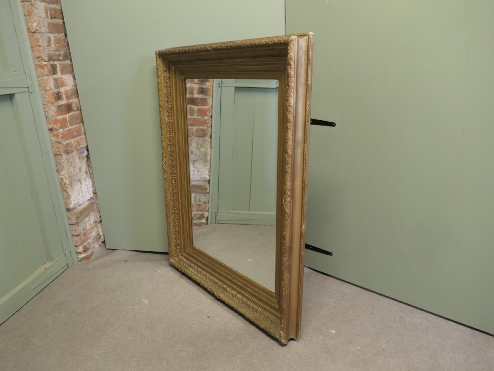 A large nineteenth-century rectangular wall mirror featuring a heavily moulded giltwood frame with classic border detailing. View III