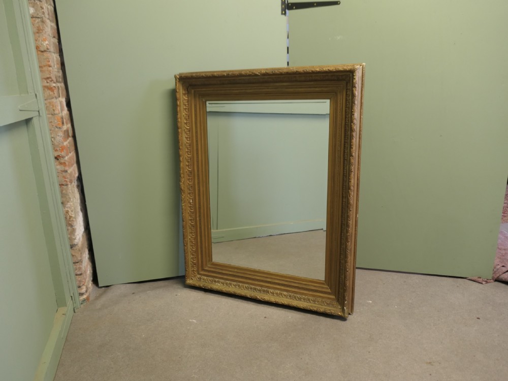 A large nineteenth-century rectangular wall mirror featuring a heavily moulded giltwood frame with classic border detailing. View V