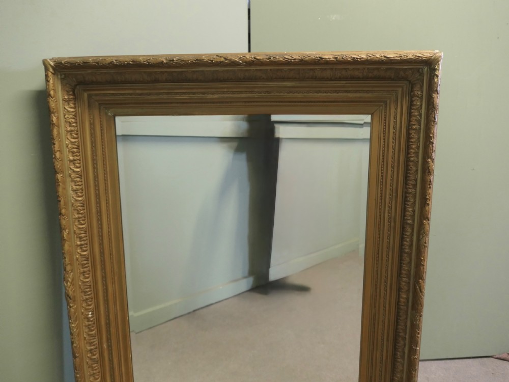 A large nineteenth-century rectangular wall mirror featuring a heavily moulded giltwood frame with classic border detailing. View VI