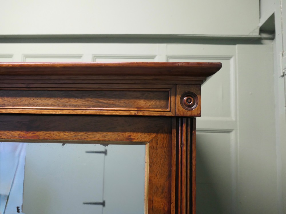 A nineteenth-century Regency rosewood four-door wardrobe with mirrored upper sections and brass stringing decoration. View IV