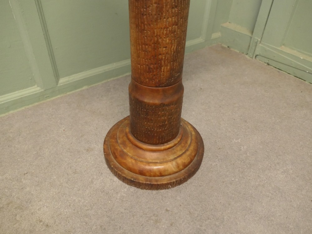 A tall honey-coloured marble pedestal column featuring a flat top surface, turned shaft with raised ring mouldings, and a heavy circular base. View II