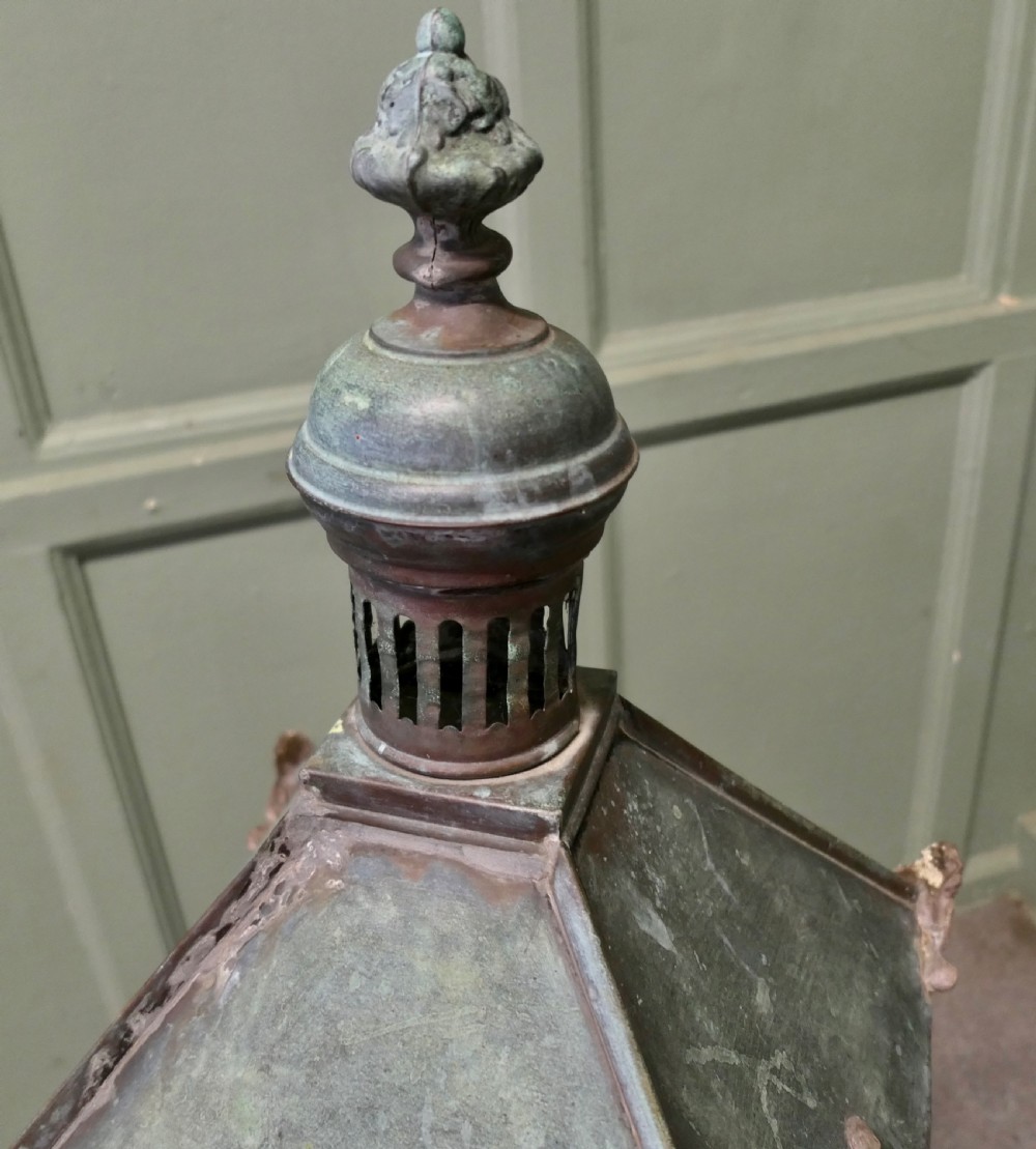 A large mid-19th century copper street lantern featuring clear glass panes, a tapered body, a pierced chimney cap with decorative finial, and a wrought iron post mount with verdigris patina. View VIII