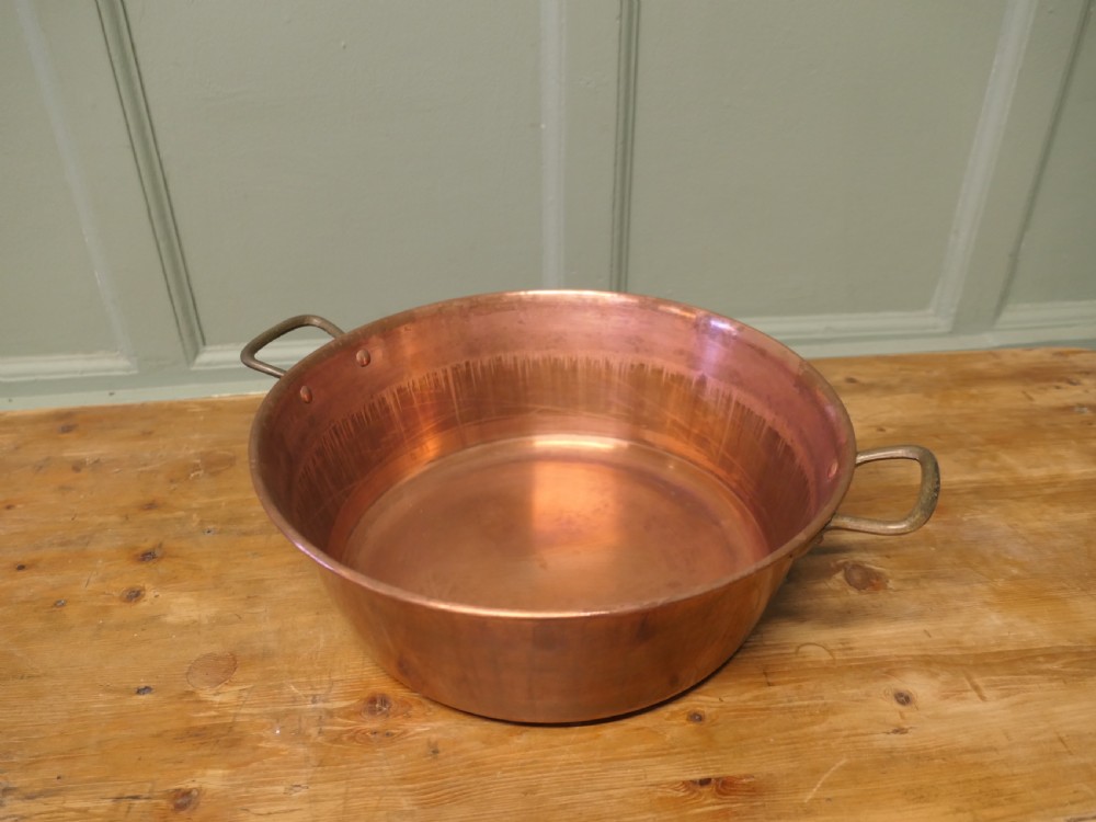 A large 19th-century circular copper jam pan with flared sides and two riveted brass side handles. View II