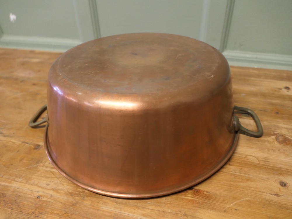A large 19th-century circular copper jam pan with flared sides and two riveted brass side handles. View III