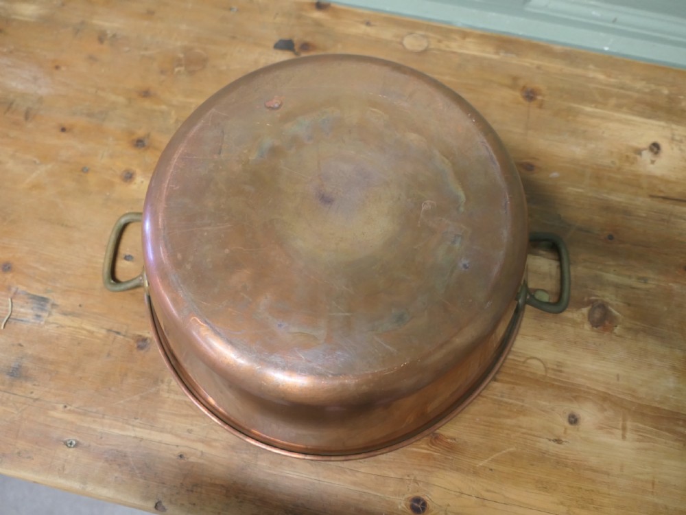 A large 19th-century circular copper jam pan with flared sides and two riveted brass side handles. View IV