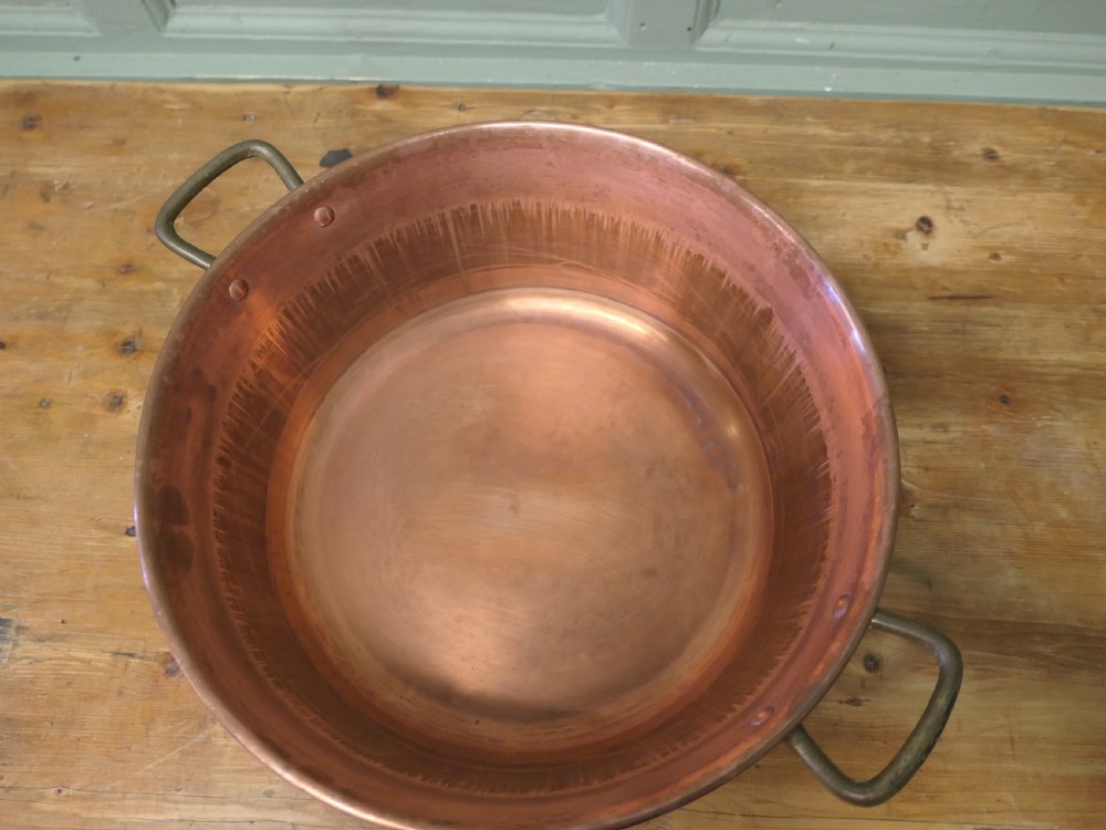 A large 19th-century circular copper jam pan with flared sides and two riveted brass side handles. View V
