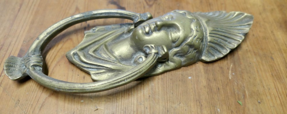 A cast brass Victorian door knocker featuring a classical female bust with a fan motif crown and an articulated oval ring. View IV
