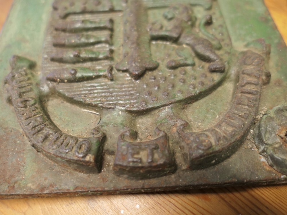 A rectangular cast iron wall plaque featuring the relief-moulded Bournemouth coat of arms with weathered green paint and visible oxidisation. View VI