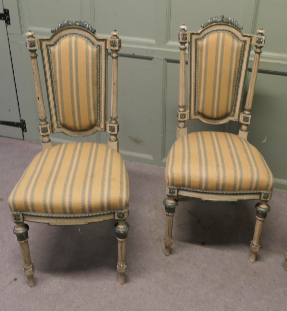 A set of four antique French salon chairs featuring carved cream and green painted frames with yellow and cream striped fabric upholstery. View III