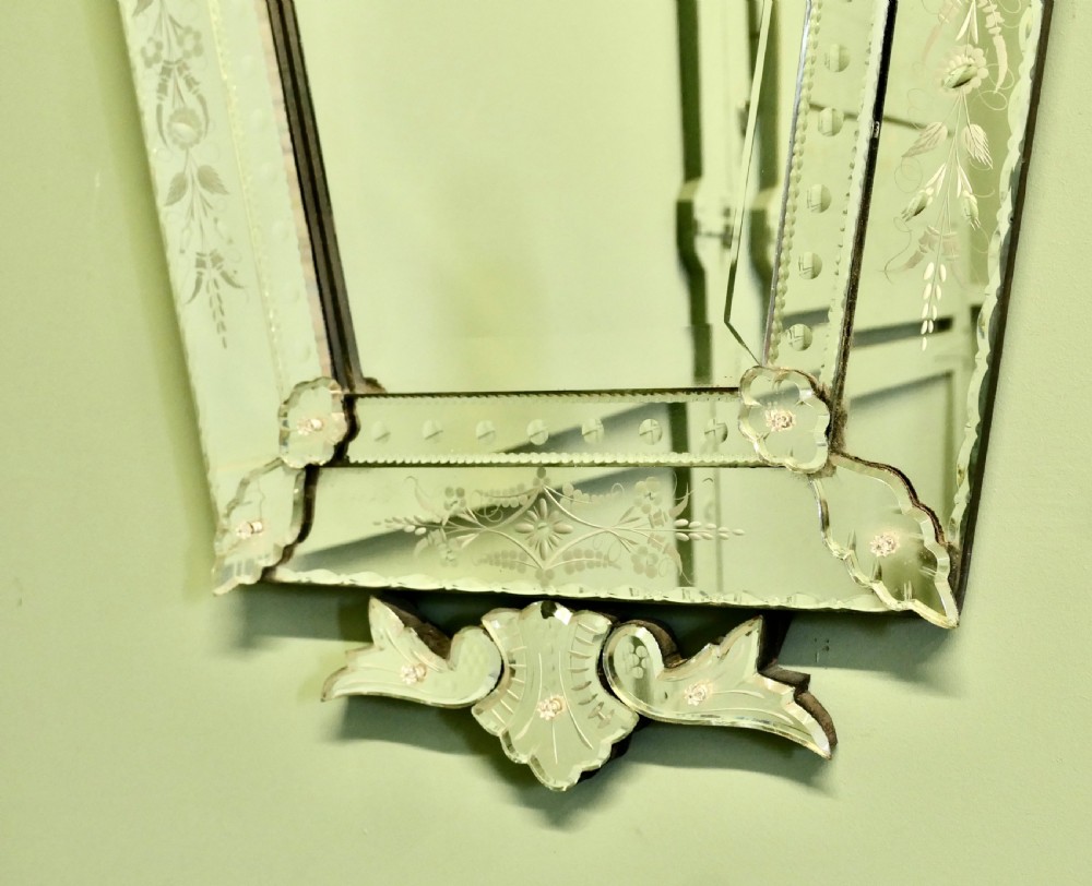A tall Art Deco Venetian wall mirror featuring hand-etched floral motifs, a contoured crest, and bevelled border panels. View III