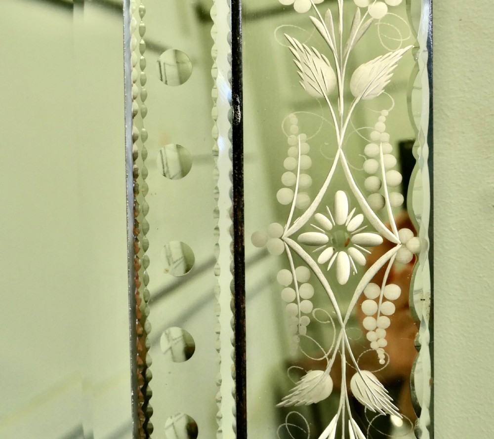 A tall Art Deco Venetian wall mirror featuring hand-etched floral motifs, a contoured crest, and bevelled border panels. View IV