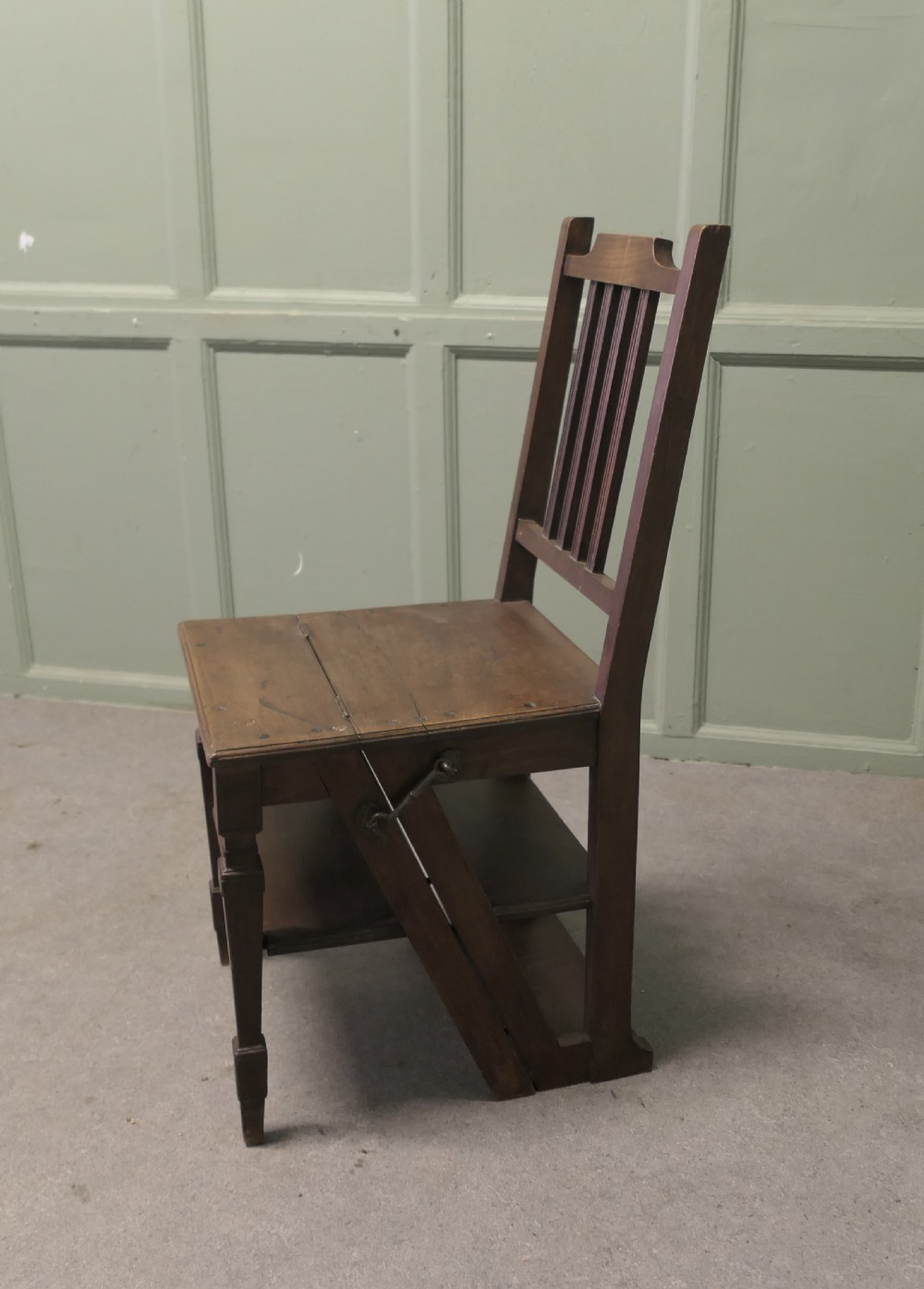 An Edwardian metamorphic dark wood chair unfolded into a four-step library ladder. View III