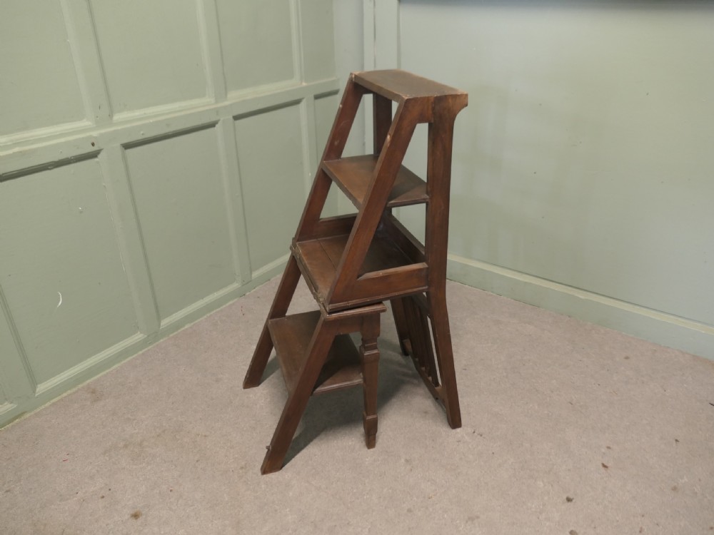 An Edwardian metamorphic dark wood chair unfolded into a four-step library ladder. View IV