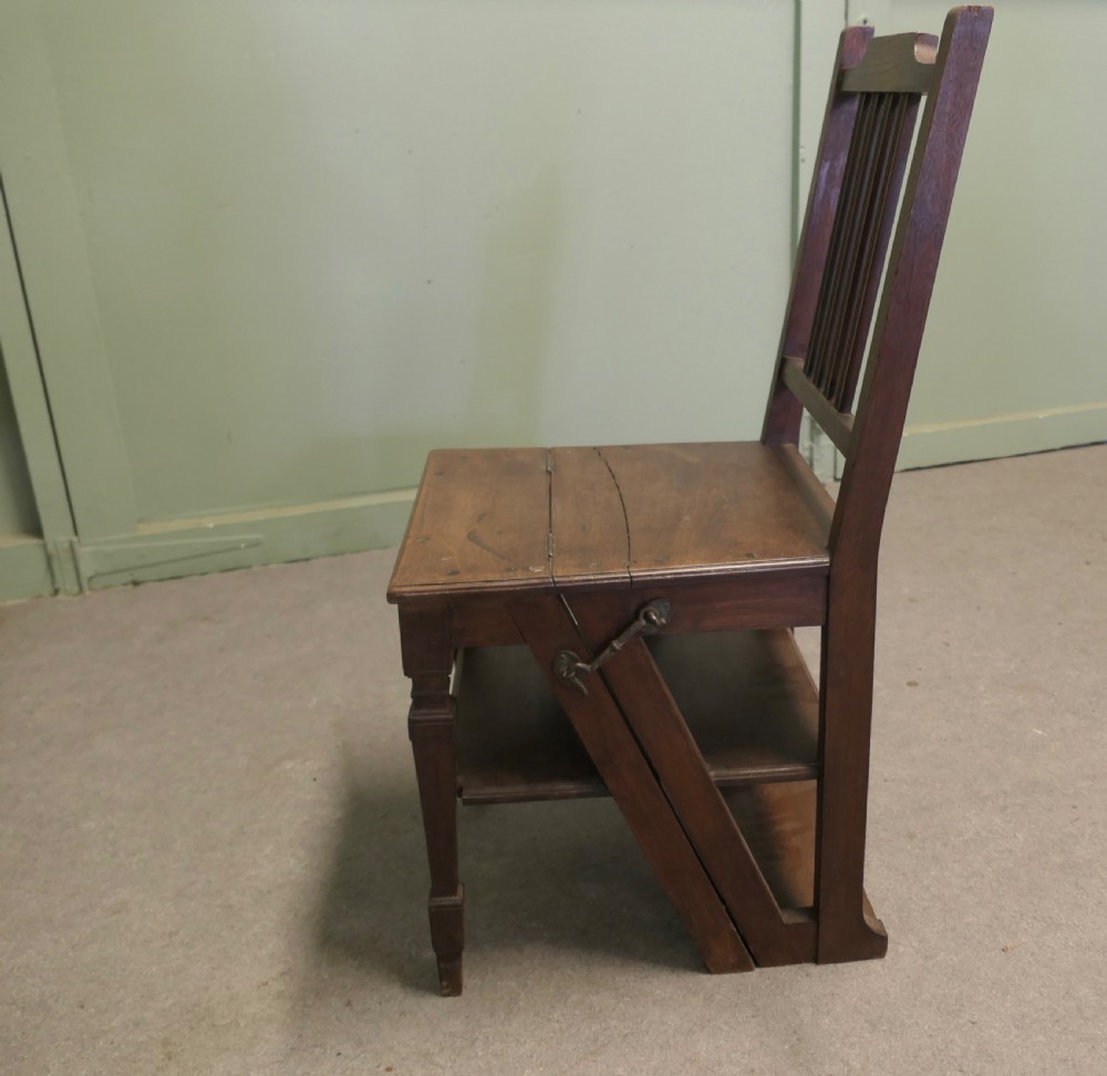 An Edwardian metamorphic dark wood chair unfolded into a four-step library ladder. View V