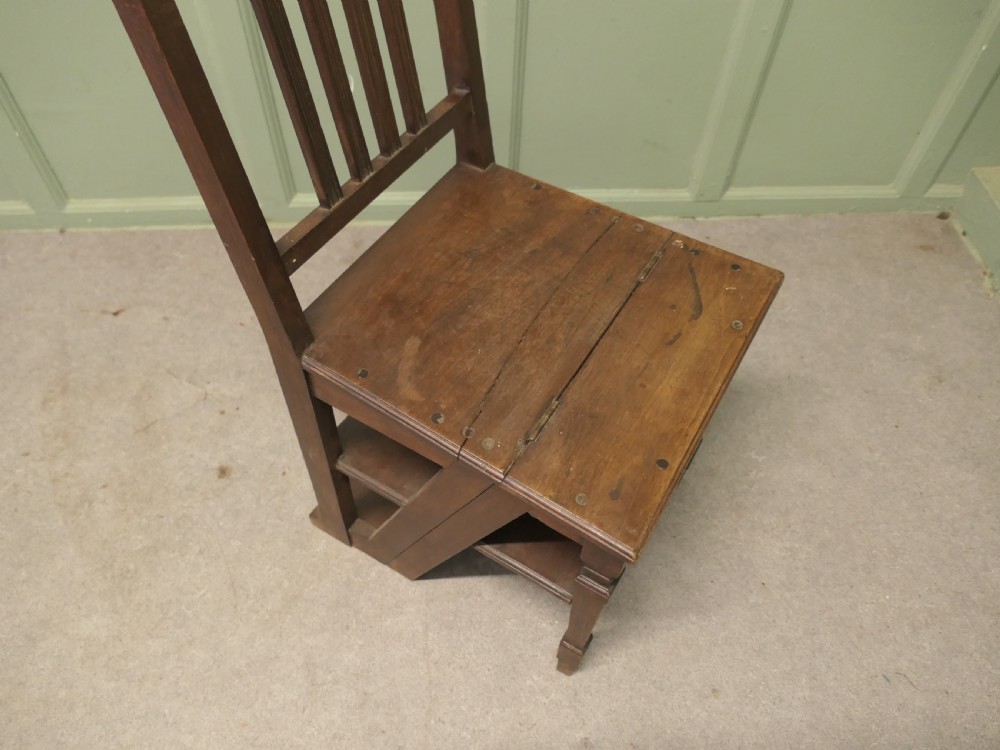 An Edwardian metamorphic dark wood chair unfolded into a four-step library ladder. View VI