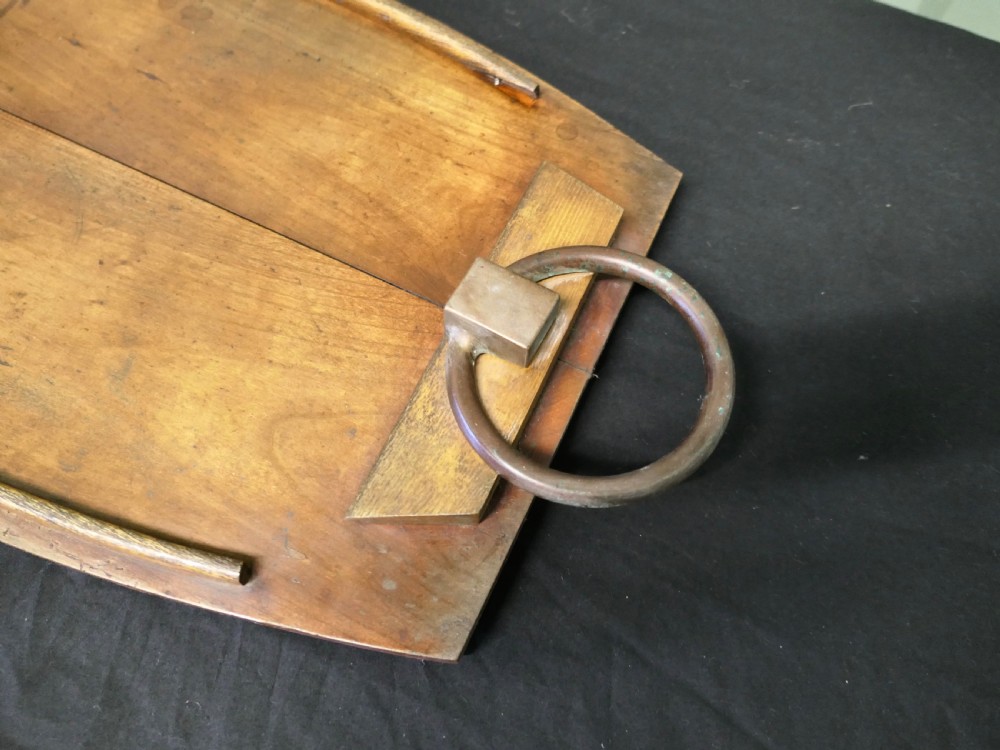 A golden elm wooden serving tray featuring raised side edges and heavy brass ring handles mounted on rectangular wooden blocks. View II