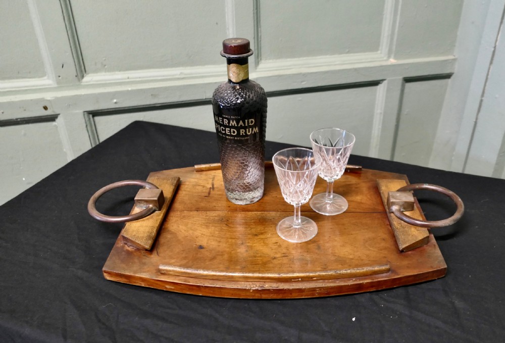A golden elm wooden serving tray featuring raised side edges and heavy brass ring handles mounted on rectangular wooden blocks. View IV