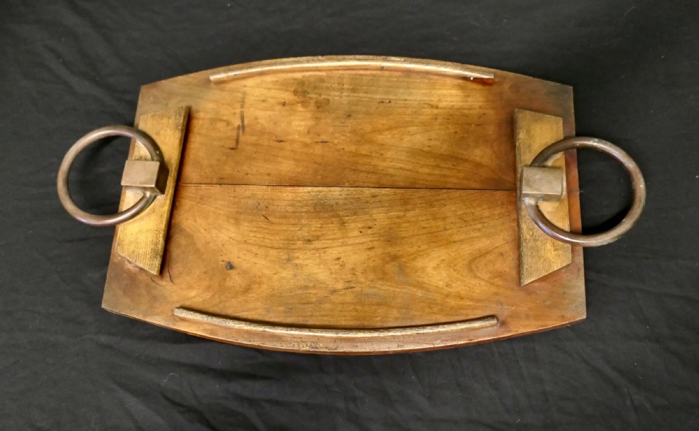 A golden elm wooden serving tray featuring raised side edges and heavy brass ring handles mounted on rectangular wooden blocks. View V