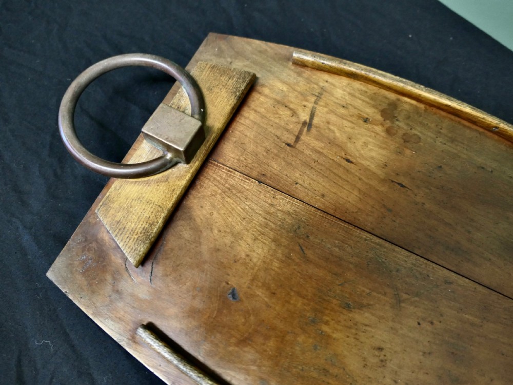 A golden elm wooden serving tray featuring raised side edges and heavy brass ring handles mounted on rectangular wooden blocks. View VI