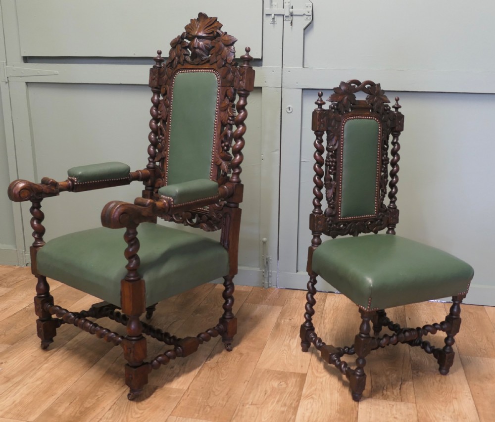 A set of ten carved oak dining chairs featuring green leather upholstery, barley twist legs, and detailed crest rails, comprising two carver armchairs and eight side chairs. View VI