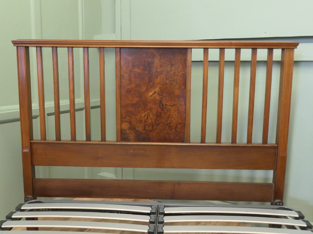 An Edwardian burr walnut double bed frame featuring a slatted headboard and footboard centered with figured walnut panels, supported by iron side rails. View II