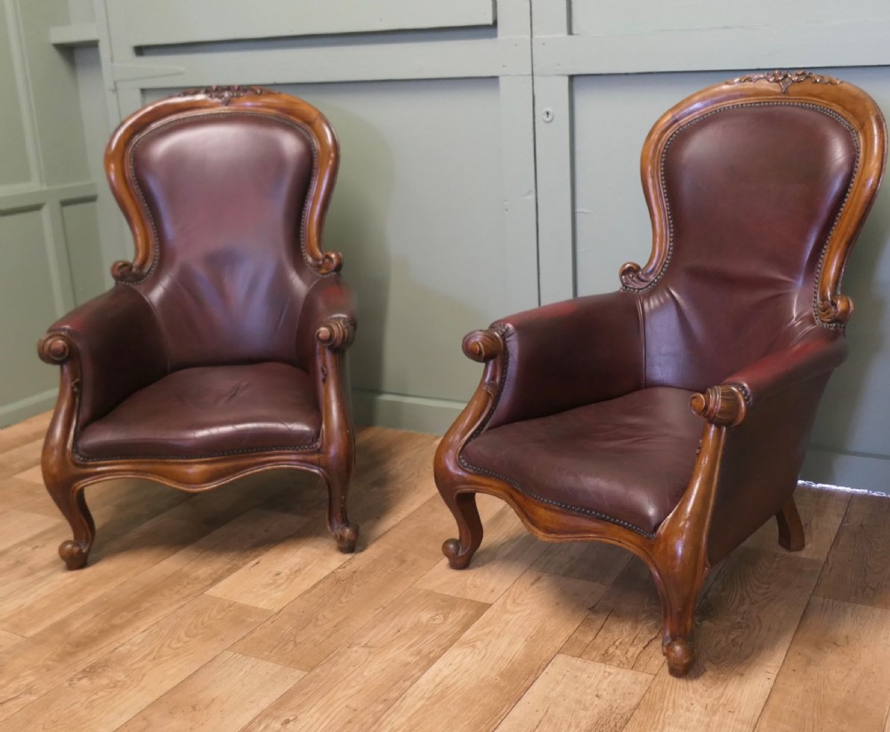 A Pair of Victorian Leather Spoon Back Easy Chairs.