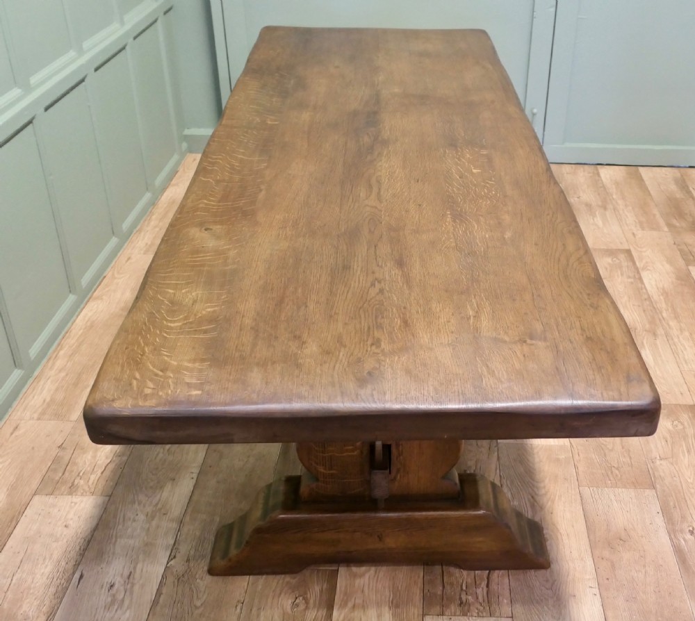 A large 19th-century French oak refectory table featuring a solid plank top, shaped trestle ends, and a central connecting stretcher. View V