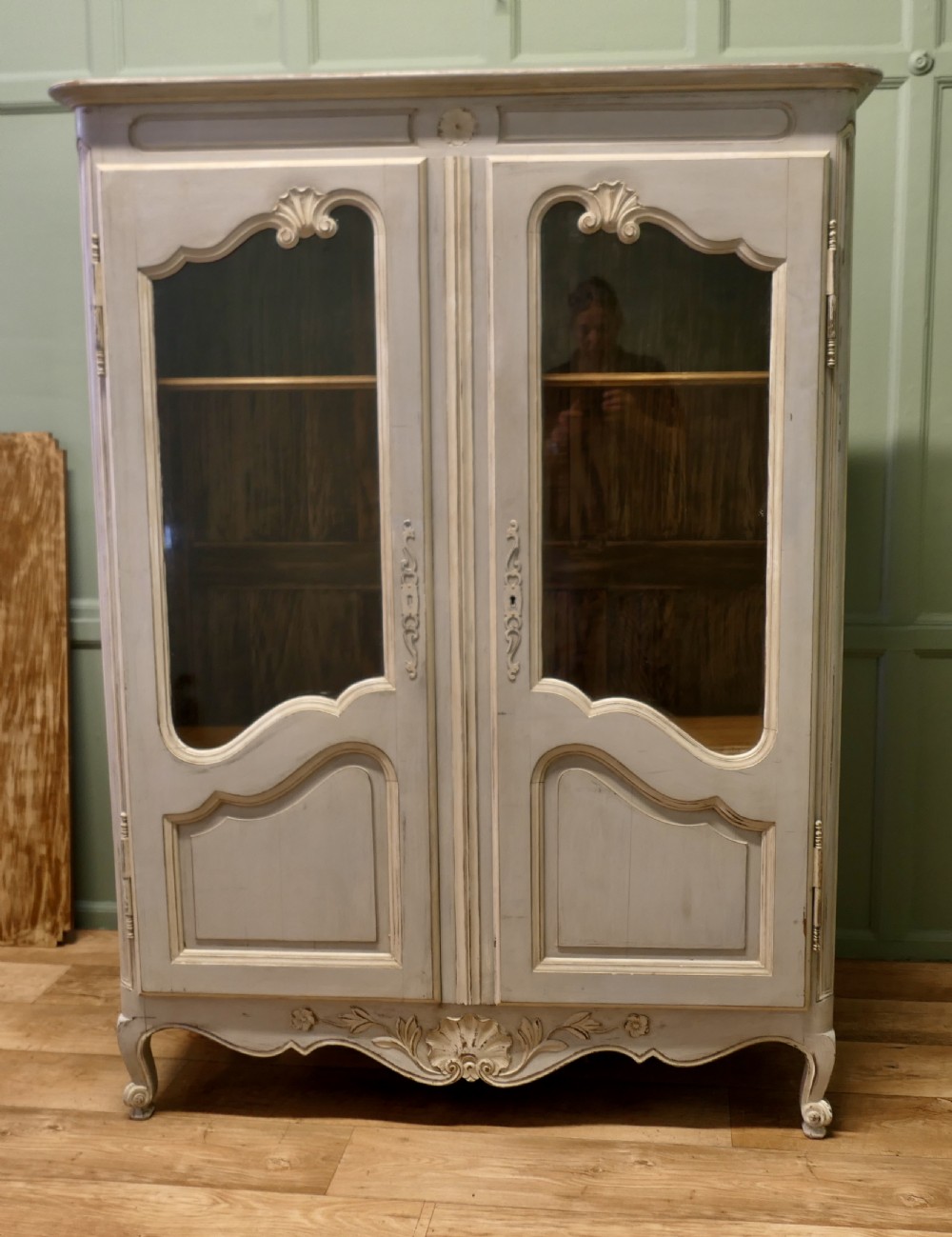 A double-door painted wooden vitrine featuring glazed upper panels with serpentine framing, carved shell lower mouldings, and cabriole legs. View II