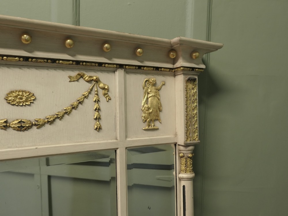 A Regency Neoclassical triple-plate overmantel mirror with off-white painted frame, gold leaf swags, relief figures, and side pilasters. View VI