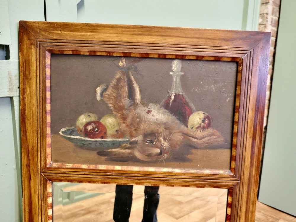 A tall rectangular timber-framed trumeau mirror featuring an inset oil painting of a game still life above a mirror panel. View IV
