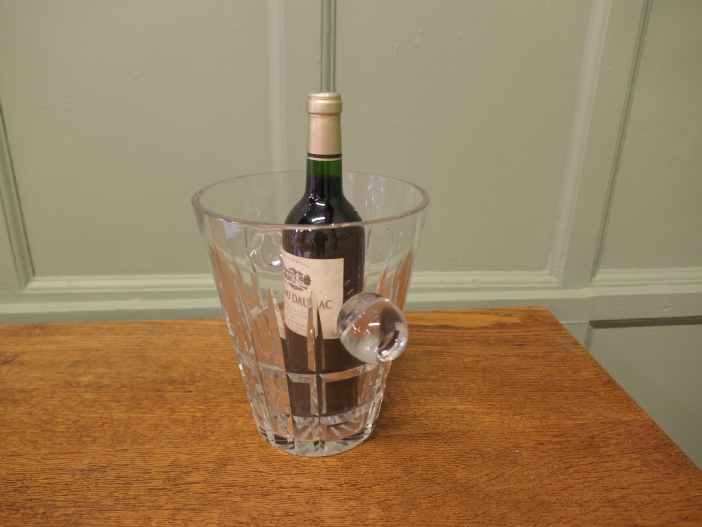 A clear hand-cut crystal ice bucket featuring geometric facets and two solid round side handles. View III