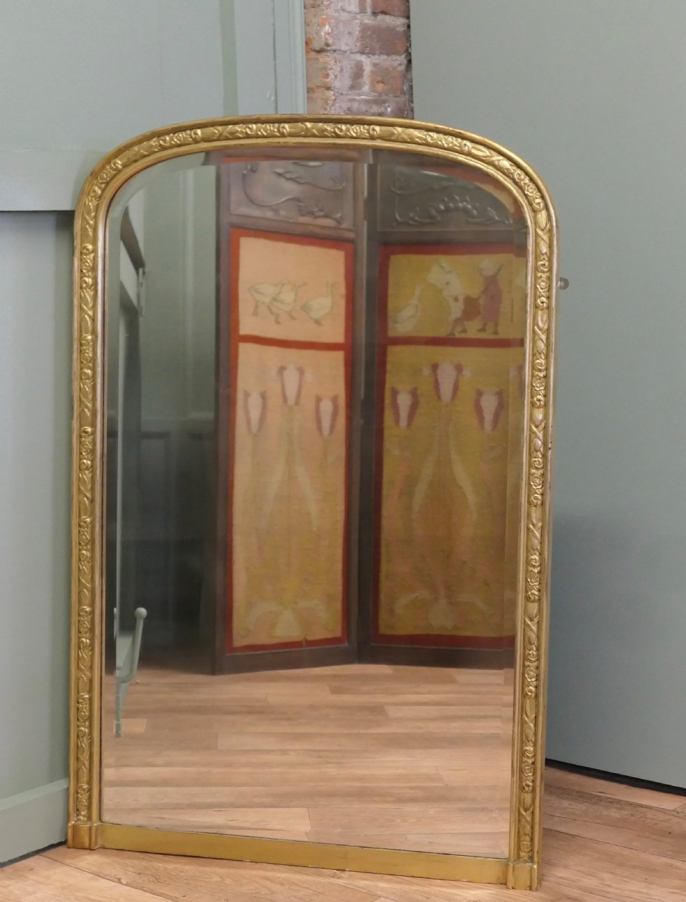 A tall 19th-century French Louis Philippe wall mirror featuring rounded upper corners and an engraved gold gilded frame. View II