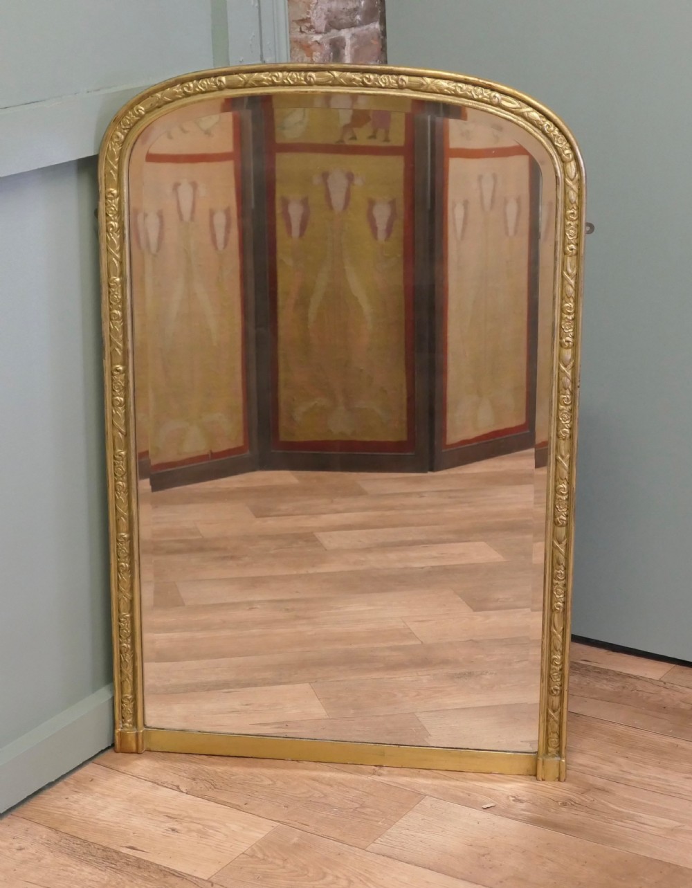 A tall 19th-century French Louis Philippe wall mirror featuring rounded upper corners and an engraved gold gilded frame. View III