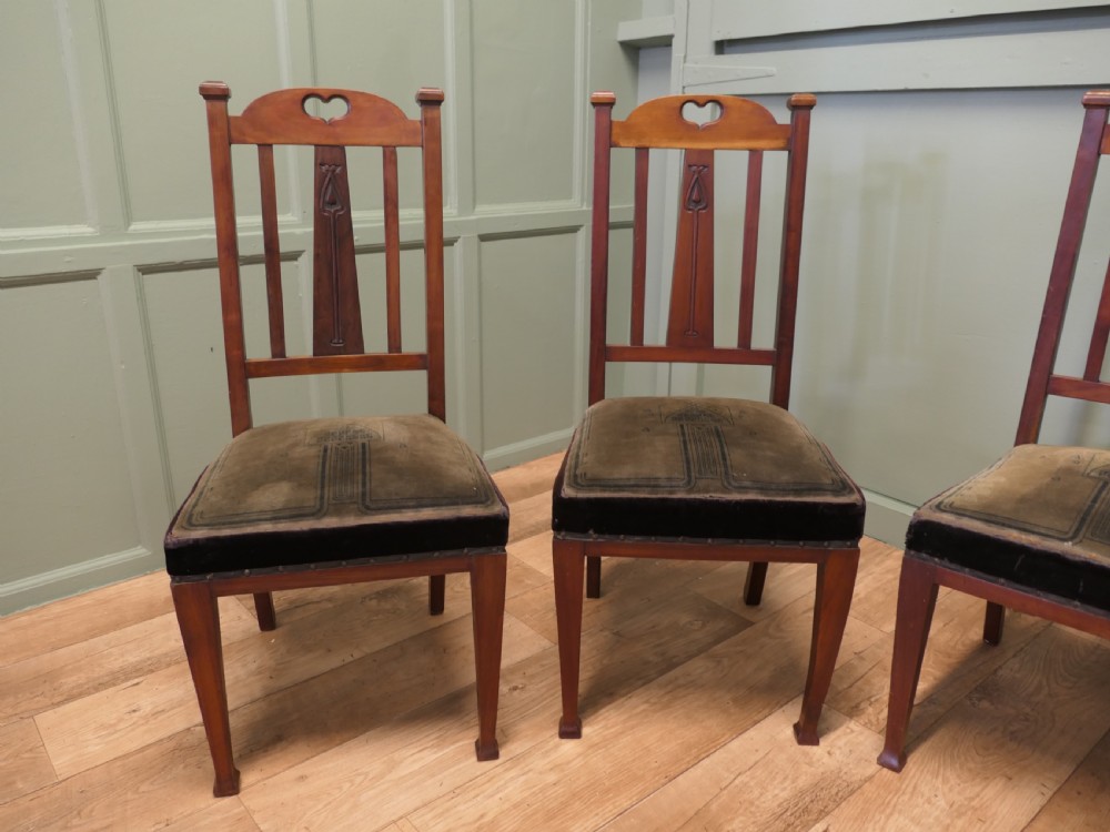 A set of six golden oak Arts and Crafts dining chairs featuring vertical slatted backs with top rail cutouts and dark green upholstered seats. View II