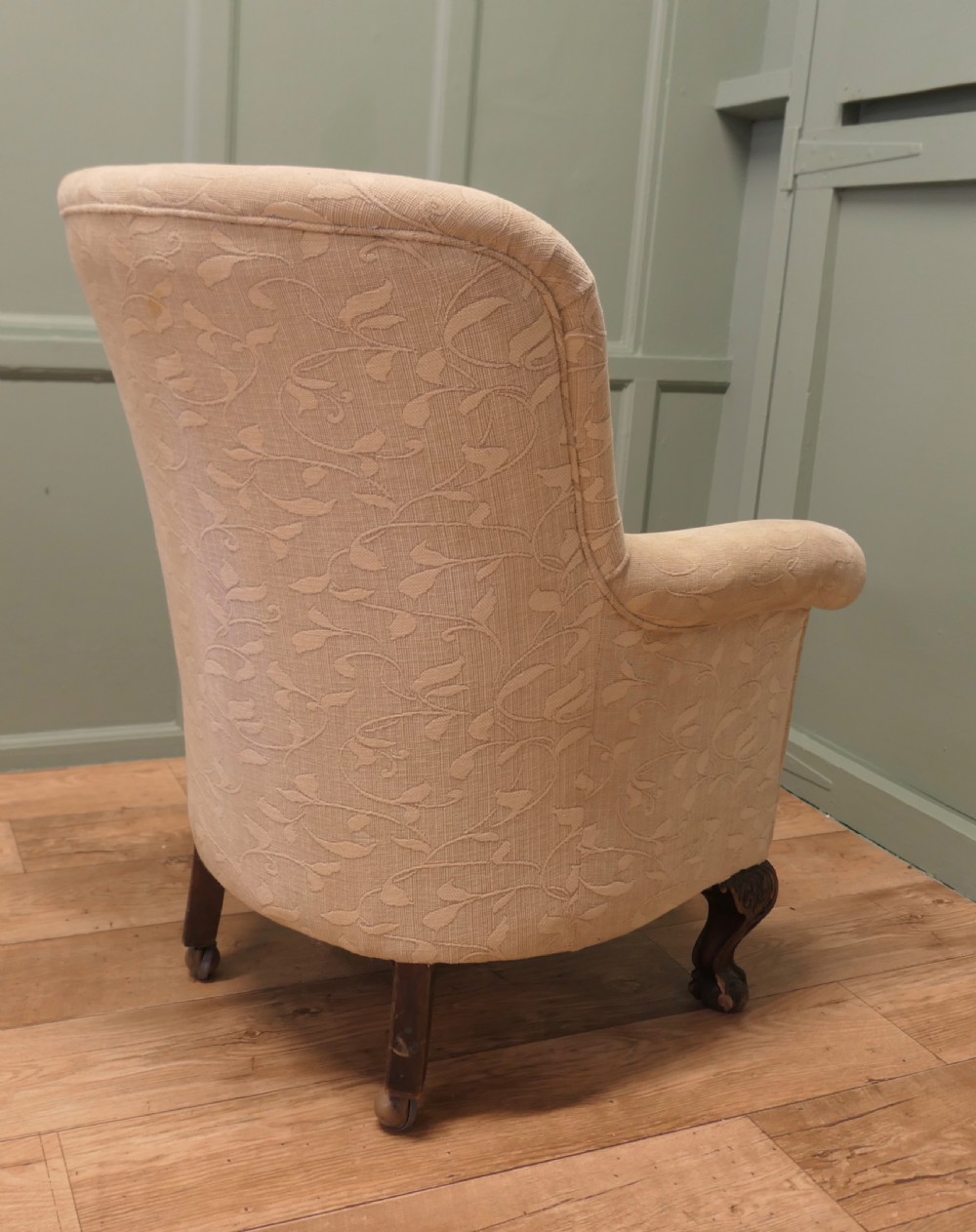 A Victorian upholstered tub armchair in cream patterned fabric with carved timber legs. View III