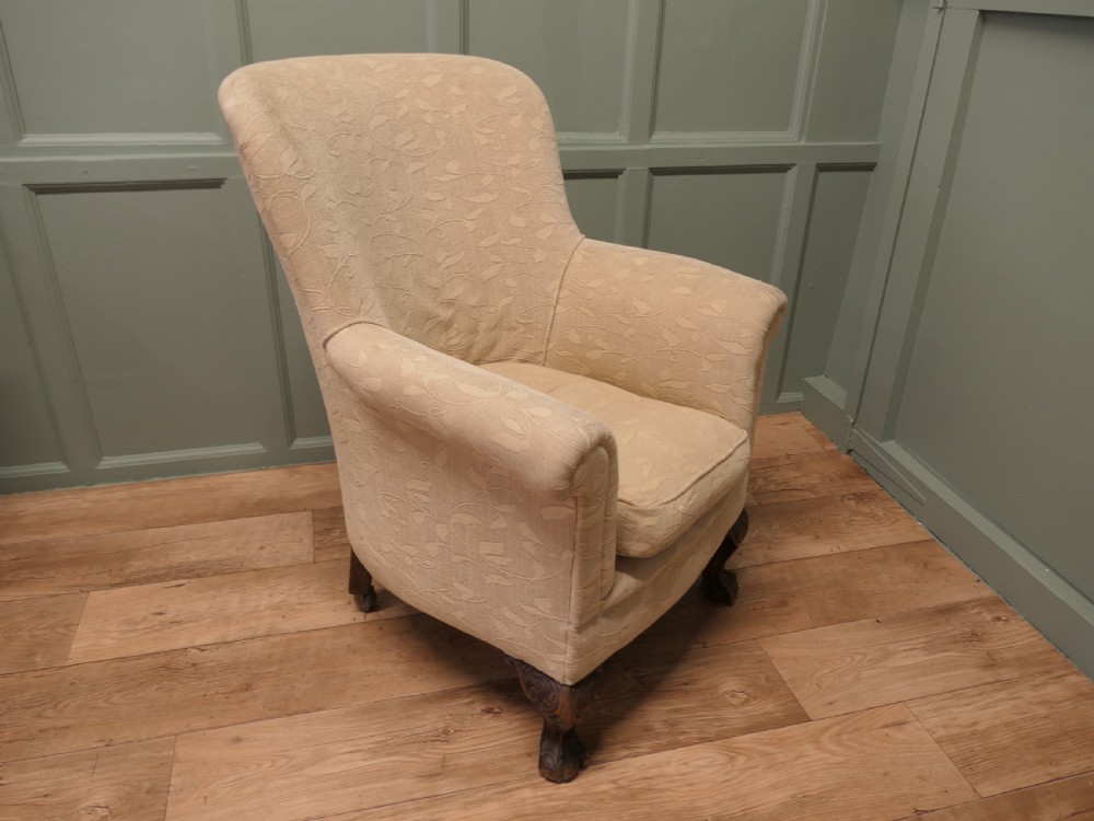 A Victorian upholstered tub armchair in cream patterned fabric with carved timber legs. View IV