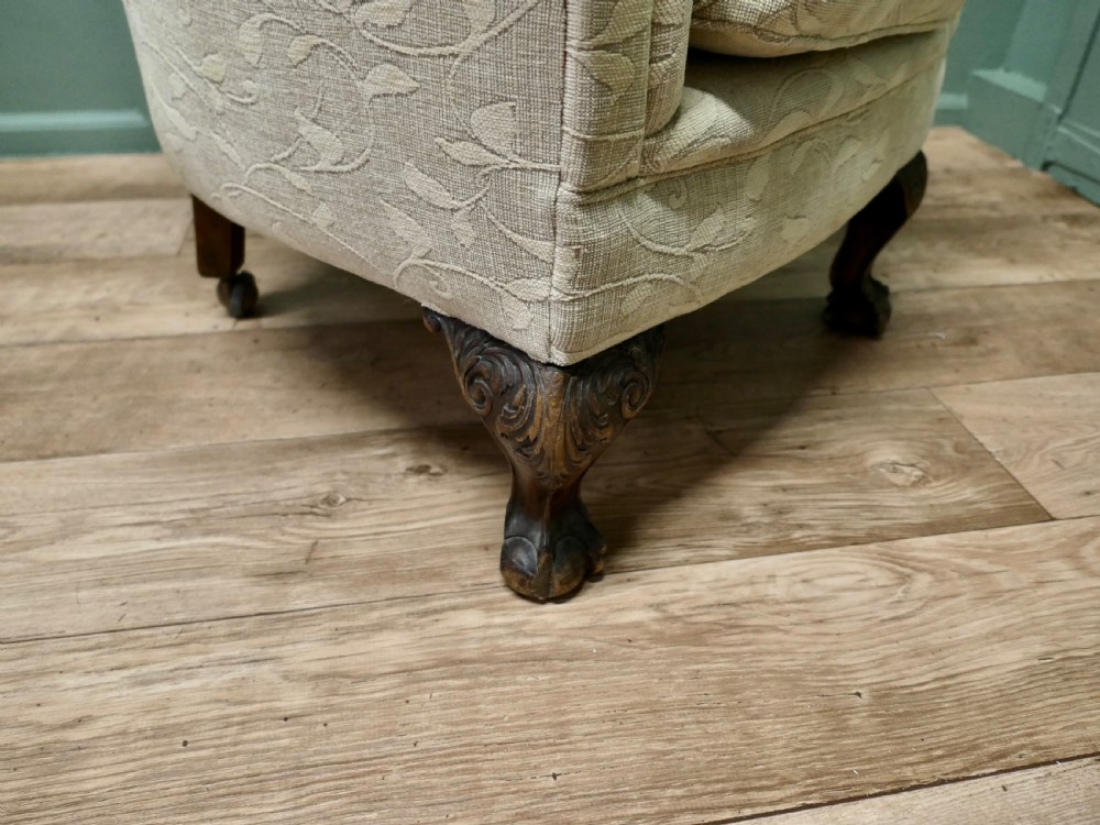 A Victorian upholstered tub armchair in cream patterned fabric with carved timber legs. View V