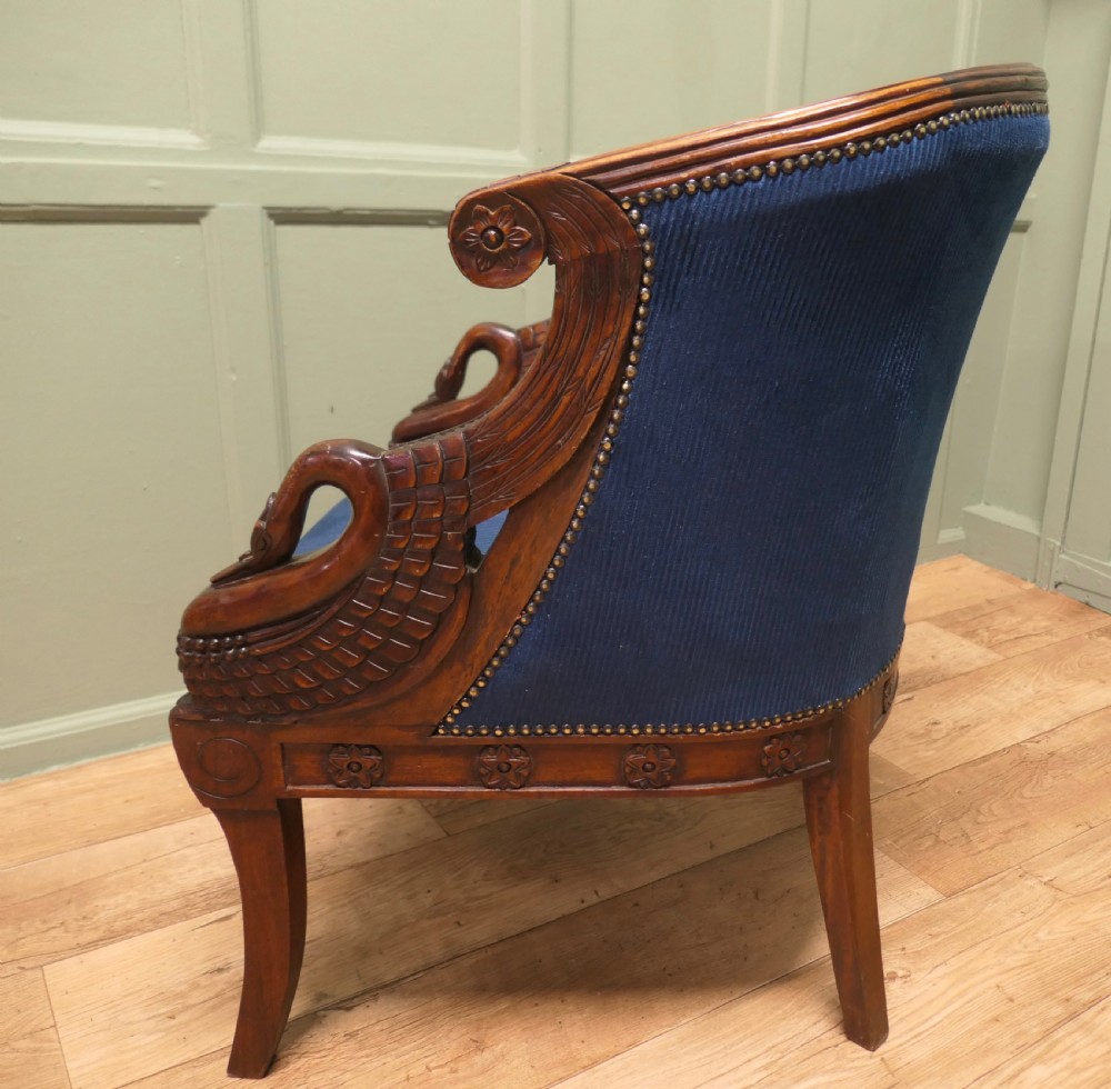 A pair of Victorian tub chairs with blue upholstery and carved mahogany frames featuring carved swan neck armrests. View III