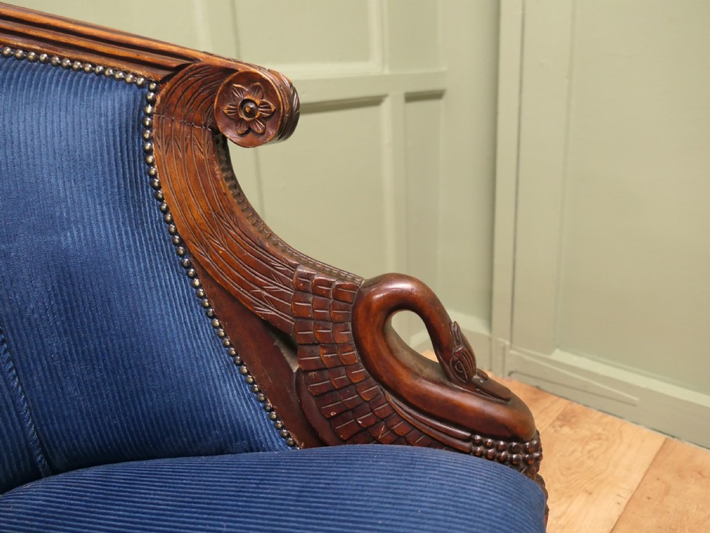 A pair of Victorian tub chairs with blue upholstery and carved mahogany frames featuring carved swan neck armrests. View VIII