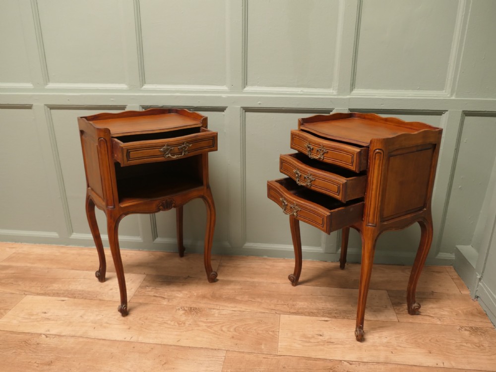 A pair of French cherry wood bedside tables featuring cabriole legs, brass handles, and carved shell motifs, one configured with an open shelf and the other with three drawers. View III