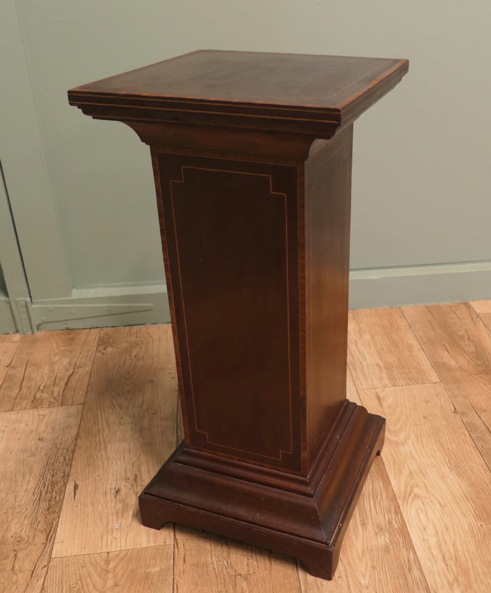 A square-topped 19th-century French wooden display pedestal featuring dark brown timber with subtle geometric string inlay along the central column and stepped base.