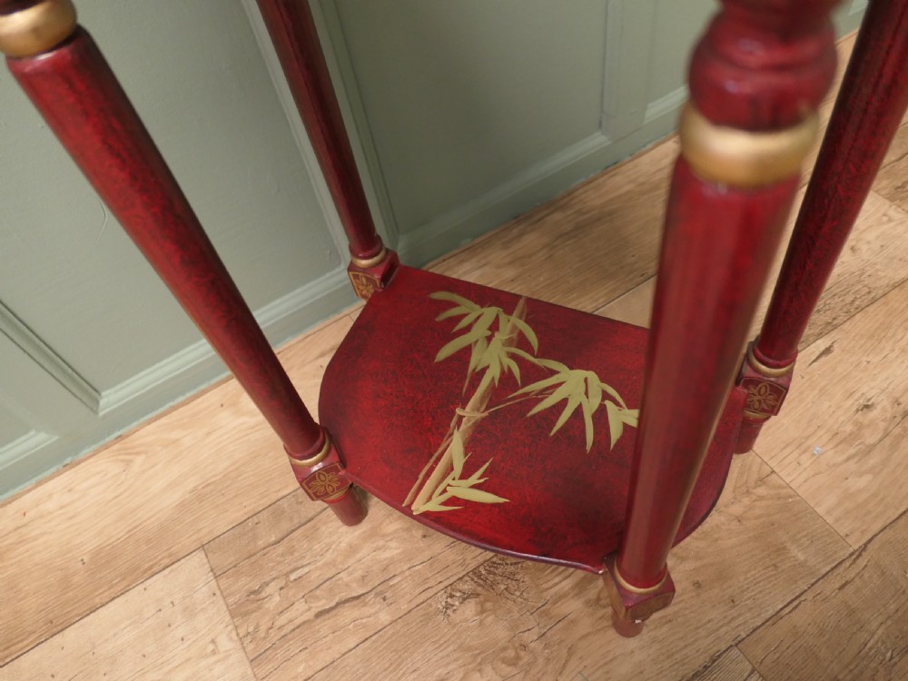 A tall red lacquer Chinoiserie side table featuring hand-painted crane and floral motifs, gilded turned legs, a single drawer, and an undershelf. View III