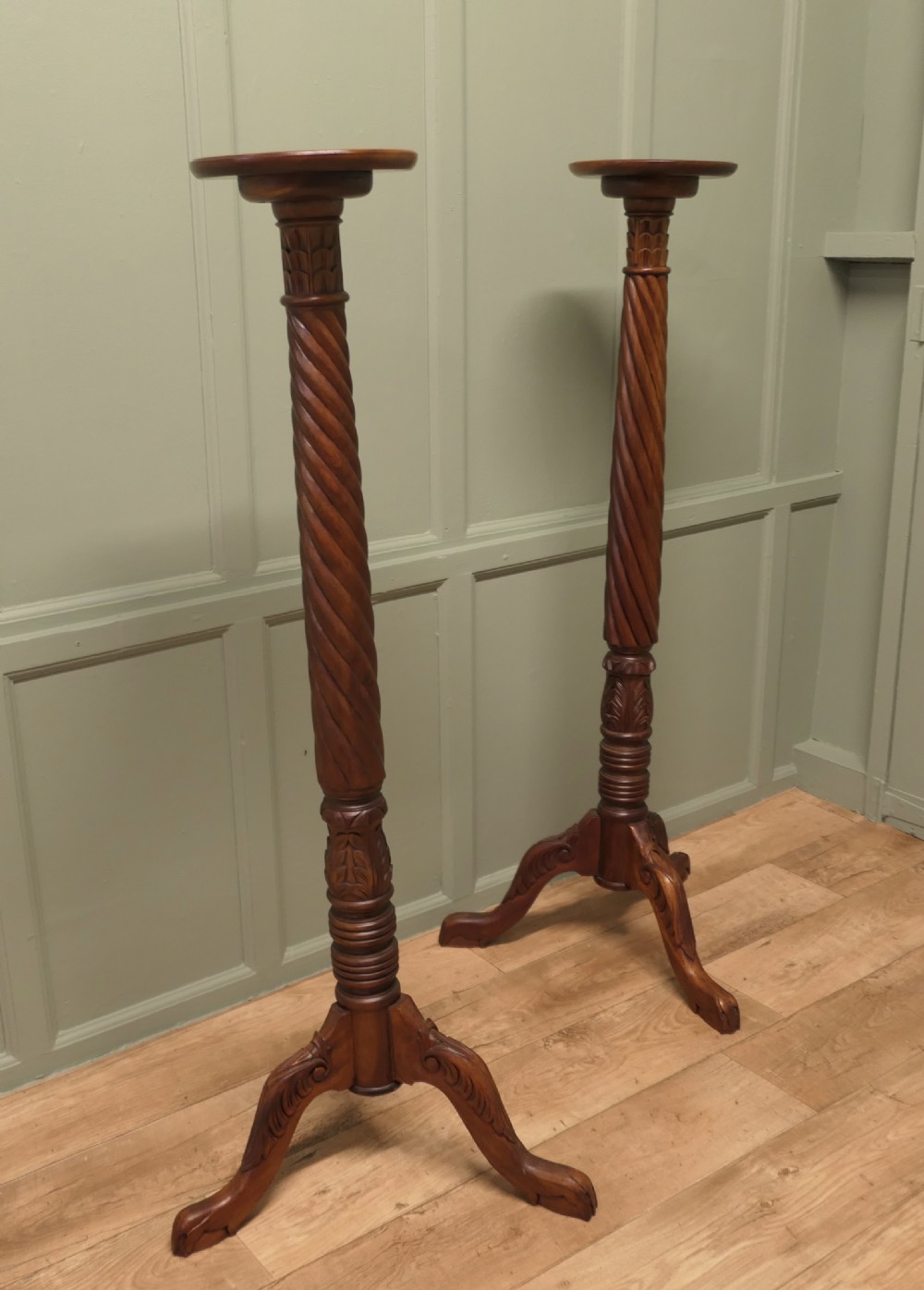 A pair of tall carved mahogany torchere stands featuring spiral shafts, foliate carving, and tripod cabriole bases. View II