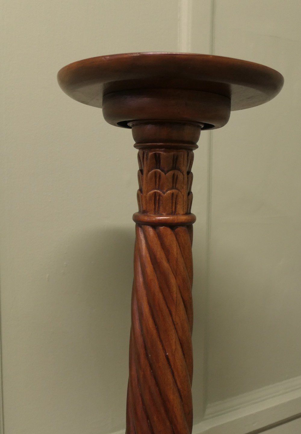 A pair of tall carved mahogany torchere stands featuring spiral shafts, foliate carving, and tripod cabriole bases. View III