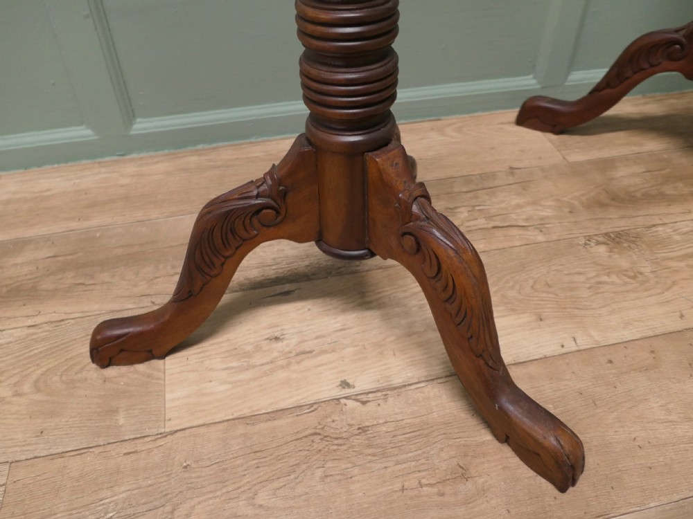 A pair of tall carved mahogany torchere stands featuring spiral shafts, foliate carving, and tripod cabriole bases. View V