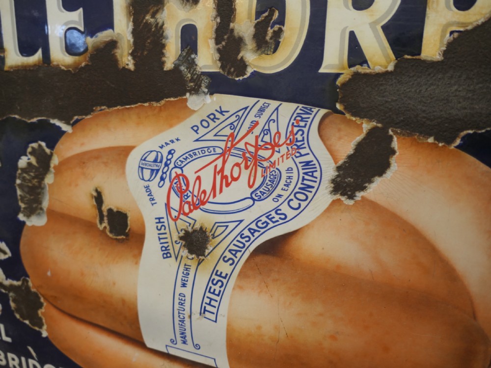 A framed antique blue and white enamel advertising sign for Palethorpes Royal Cambridge sausages featuring a central pictorial illustration. View IV