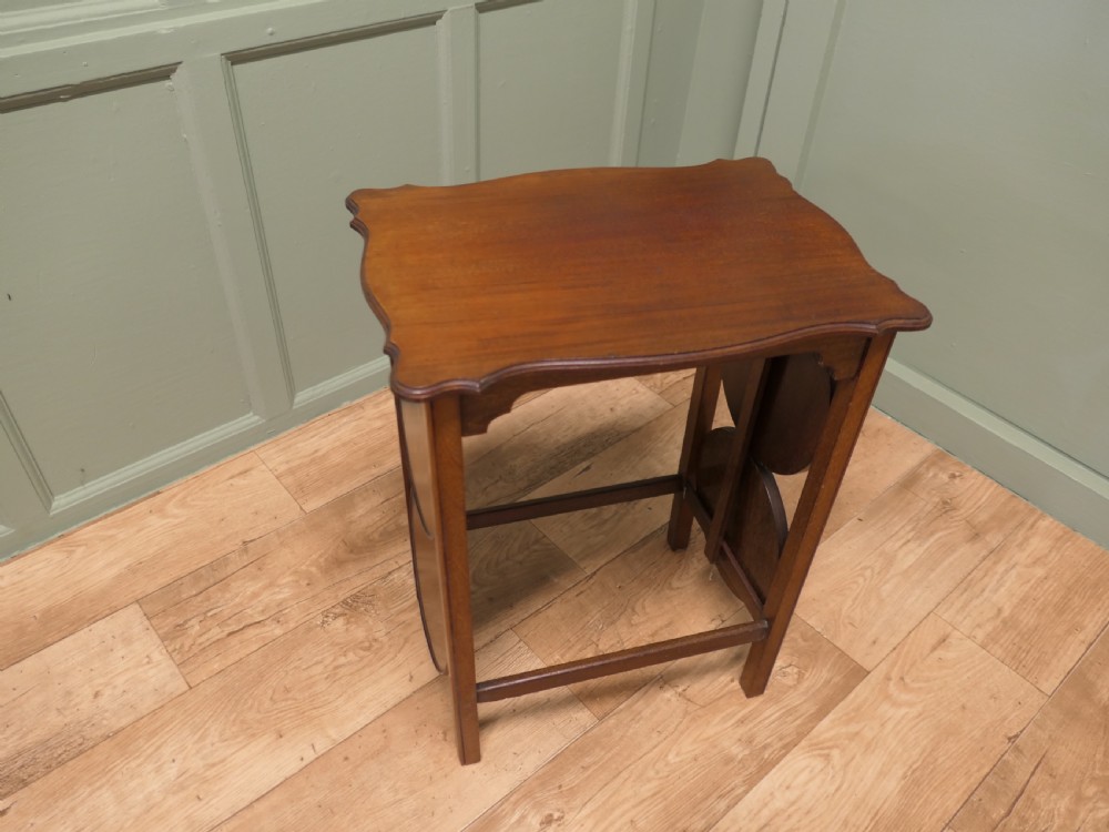 An Edwardian mahogany side table featuring a flat rectangular top and two side-mounted folding circular tiered cake stands. View III